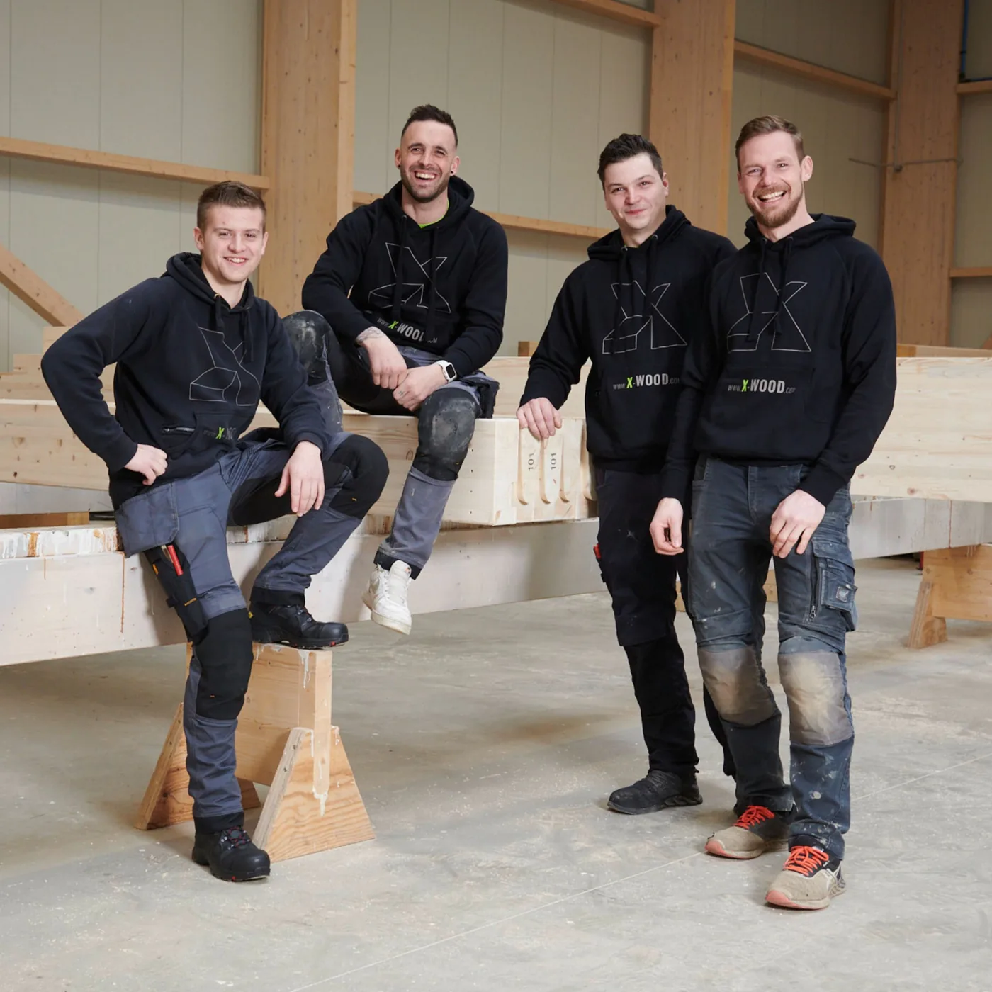X-Wood® assembly team in front of prefabricated glulam beams
