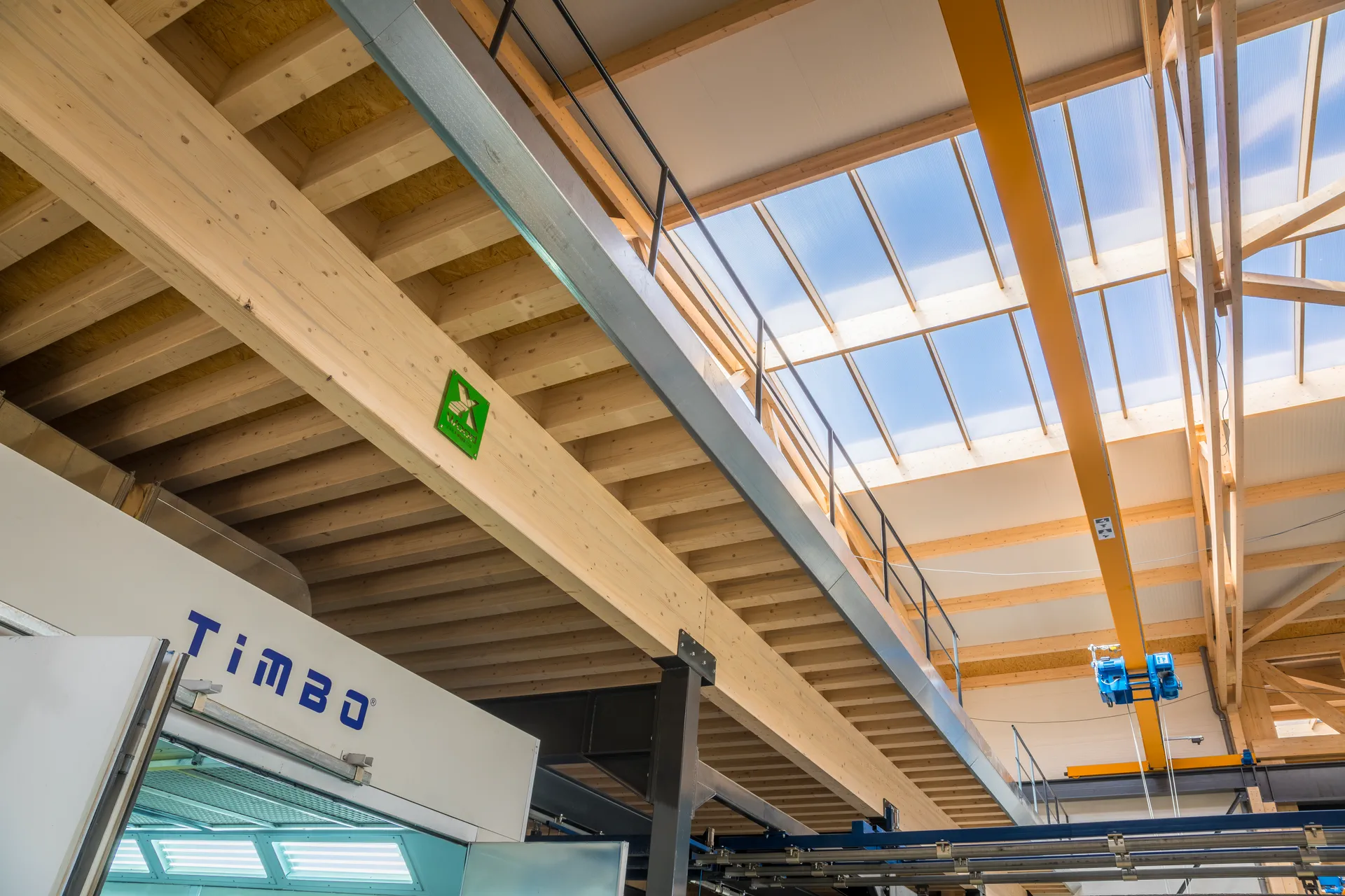 Bright interior of an X-Wood® hall with an exposed timber ceiling
