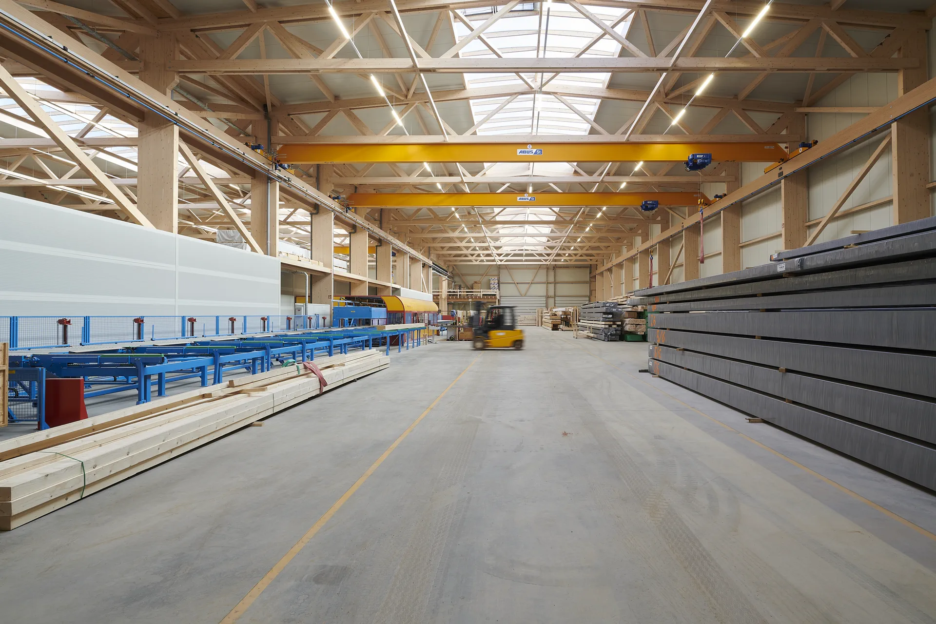 Interior of an X-Wood® timber hall with an exposed timber roof structure