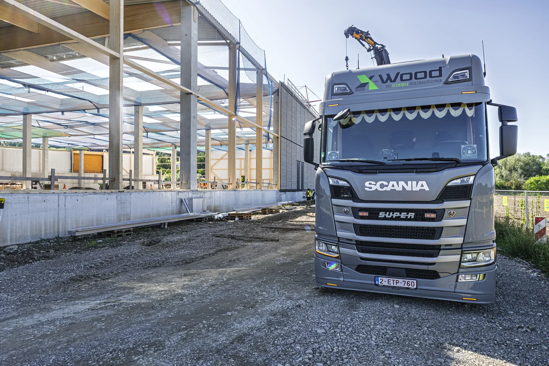Two fitters placing a glulam beam from a cherry picker